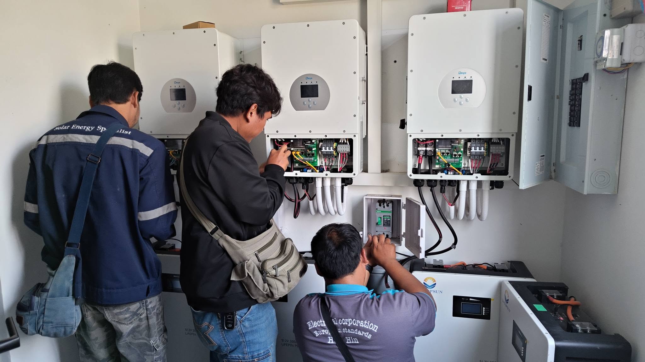 Technicians configuring a solar battery system